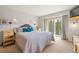 Comfortable bedroom featuring a private balcony with beautiful views of the surrounding forest at 100 River Park Dr # A, Breckenridge, CO 80424