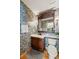 Stylish powder room with eye-catching wallpaper, modern fixtures, and wood flooring at 100 River Park Dr # A, Breckenridge, CO 80424