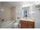 Bathroom with shower/tub combo and wood vanity at 1551 Larimer St # 2805, Denver, CO 80202
