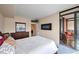 Bright bedroom with city view, fireplace, and access to private balcony at 1551 Larimer St # 2805, Denver, CO 80202
