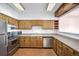 Kitchen with wood cabinets and stainless steel appliances at 1551 Larimer St # 2805, Denver, CO 80202