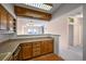 Kitchen with wood cabinets and breakfast bar at 1551 Larimer St # 2805, Denver, CO 80202