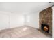 Living room with stone fireplace, carpeted floors and natural light from a window and glass door at 4333 S Andes Way # 203, Aurora, CO 80015