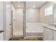 Bright bathroom with tiled shower, separate bathtub, and a modern vanity with nice fixtures and hardware at 48250 Shetland Dr, Bennett, CO 80102