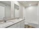 This bathroom features a double sink vanity with a large mirror and a shower and bathtub combo at 48250 Shetland Dr, Bennett, CO 80102