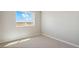Cozy bedroom with neutral carpeting, a large window overlooking a field, and neutral paint at 48250 Shetland Dr, Bennett, CO 80102