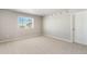 Spacious bedroom featuring neutral carpeting and a window for natural light to brighten the space at 48250 Shetland Dr, Bennett, CO 80102