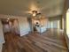 Spacious living room with hardwood floors, a ceiling fan, and lots of natural light at 48250 Shetland Dr, Bennett, CO 80102