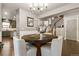 Open dining room with wood floors, neutral walls, and views of kitchen and staircase at 8827 Gore St, Arvada, CO 80007