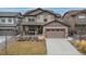 Charming two-story home featuring manicured lawn, welcoming front porch, and a two-car garage at 8827 Gore St, Arvada, CO 80007