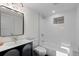 Clean basement bathroom with white subway tiles, a bathtub, and a modern vanity at 817 29Th St, Denver, CO 80205