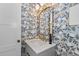 Stylish powder room with patterned wallpaper and a modern vanity at 817 29Th St, Denver, CO 80205