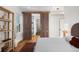 Bright bedroom with hardwood floors and barn door leading to en-suite bathroom at 817 29Th St, Denver, CO 80205