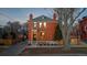 Brick two-story home with a front porch and mature trees in the yard at 817 29Th St, Denver, CO 80205