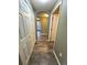 Hallway with wood-look floors and doors to bedrooms at 17443 Nature Walk Trail # 102, Parker, CO 80134