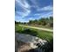 A paved pathway winds through a grassy area with trees and a fence at 17443 Nature Walk Trail # 102, Parker, CO 80134