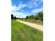 Paved pathway meanders through green space, offering scenic views at 17443 Nature Walk Trail # 102, Parker, CO 80134