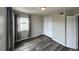 Bedroom with wood flooring, closet and window with gray curtains at 12931 Ironstone Way # 303, Parker, CO 80134