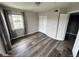 Bedroom with wood flooring, closet and window with gray curtains at 12931 Ironstone Way # 303, Parker, CO 80134