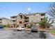 Inviting multi-story condo building featuring brick accents and outdoor balconies, surrounded by a well-maintained landscape at 12931 Ironstone Way # 303, Parker, CO 80134