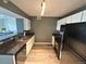 Galley kitchen featuring stainless sink, granite countertops, white cabinets and appliances at 12931 Ironstone Way # 303, Parker, CO 80134