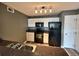 Well-lit kitchen featuring white cabinets, granite countertops, and black appliances at 12931 Ironstone Way # 303, Parker, CO 80134