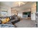 Spacious living room with neutral decor, a ceiling fan, plush carpet, and an open layout leading to the kitchen and dining area at 12931 Ironstone Way # 303, Parker, CO 80134