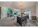 Inviting open-concept living area featuring a fireplace, dining area, and a sliding glass door for easy access to the balcony at 12931 Ironstone Way # 303, Parker, CO 80134