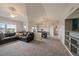 Bright living room featuring vaulted ceilings, neutral paint, ceiling fan, and open access to the dining area at 12931 Ironstone Way # 303, Parker, CO 80134