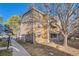 View of a three-story condo building with a mix of stone and wood siding on a sunny day at 1074 S Dearborn St # 108, Aurora, CO 80012