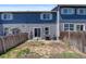 Backyard with wood fence, sliding glass door, patio and grill creates an inviting outdoor space at 11050 Gaylord St, Northglenn, CO 80233