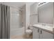 Bathroom features shower-tub combo, modern vanity, and ample lighting at 11050 Gaylord St, Northglenn, CO 80233