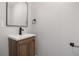 Bathroom with updated vanity, dark fixtures, and modern towel rack at 11050 Gaylord St, Northglenn, CO 80233