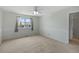 Carpeted bedroom with wainscoting, window, and ceiling fan at 11050 Gaylord St, Northglenn, CO 80233