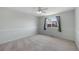 Carpeted bedroom with wainscoting, window, and ceiling fan at 11050 Gaylord St, Northglenn, CO 80233