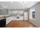 Bright kitchen features white cabinets and appliances, offering a clean and modern look at 11050 Gaylord St, Northglenn, CO 80233