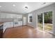 Bright kitchen features white cabinets, modern appliances, and sliding glass door to backyard at 11050 Gaylord St, Northglenn, CO 80233
