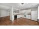 Open kitchen layout featuring white cabinets, modern appliances, and seamless flow to the living area at 11050 Gaylord St, Northglenn, CO 80233