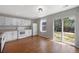 Light-filled kitchen boasts white appliances, ample counter space, and hardwood floors leading to the yard at 11050 Gaylord St, Northglenn, CO 80233