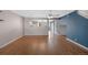 Bright and airy living room featuring hardwood floors, a bold accent wall and lots of light at 11050 Gaylord St, Northglenn, CO 80233