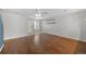 Inviting living room showcasing hardwood floors, a ceiling fan, and minimalist shelving at 11050 Gaylord St, Northglenn, CO 80233