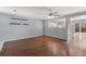 Spacious living room features hardwood floors, a ceiling fan, and a seamless view into the kitchen at 11050 Gaylord St, Northglenn, CO 80233