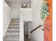 Inviting entryway featuring a staircase and a stylish, bright orange front door at 4381 Dixon Dr, Westminster, CO 80031