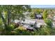 View of a grey house with a wooden deck, a well kept lawn, and mature trees around it at 4381 Dixon Dr, Westminster, CO 80031