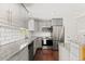 Modern kitchen featuring stainless steel appliances, granite countertops, and gray cabinets at 4381 Dixon Dr, Westminster, CO 80031