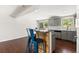 Open living area featuring wood floors, a breakfast bar, and access to the kitchen at 4381 Dixon Dr, Westminster, CO 80031