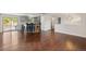 Open-concept living and kitchen area with wood floors, breakfast bar, and sliding glass doors to outdoor deck at 4381 Dixon Dr, Westminster, CO 80031