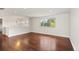 Bright living area with wood floors, decorative lighting, and large window with backyard view at 4381 Dixon Dr, Westminster, CO 80031