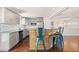 Open floor plan with breakfast bar, stainless steel appliances, and wood floors at 4381 Dixon Dr, Westminster, CO 80031