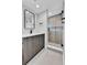 Bathroom with modern vanity and a glass enclosed shower with modern fixtures and white tiling at 2162 S Ash St, Denver, CO 80222